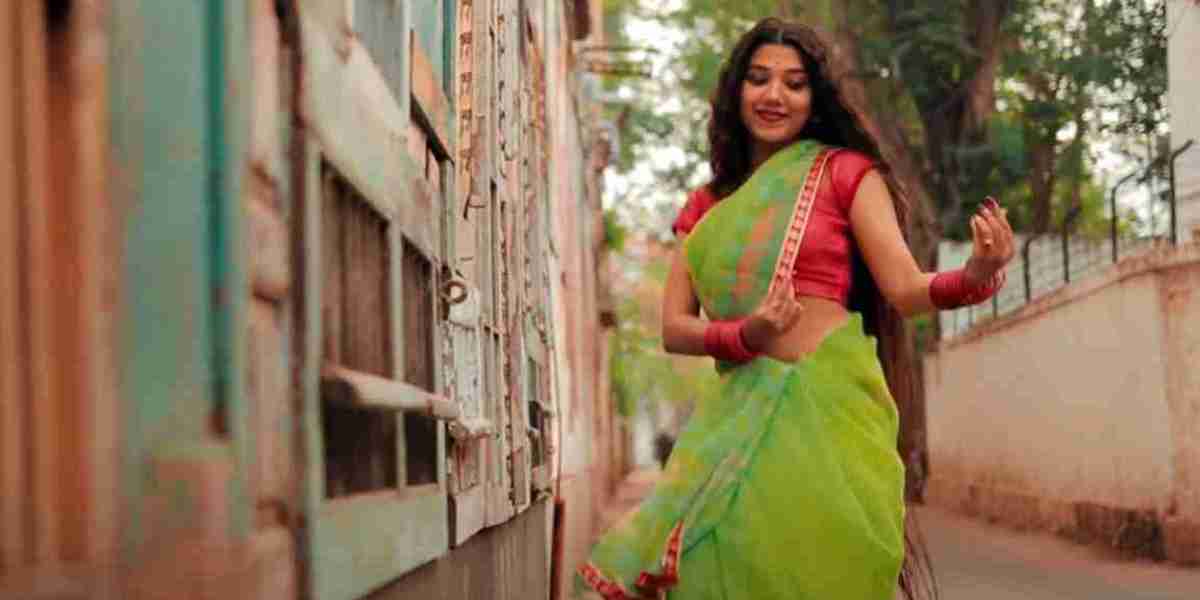 A beautiful young woman danced wildly in a green saree on an empty street